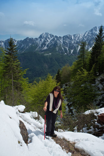 Woman walking in a snowy trail in the mountains