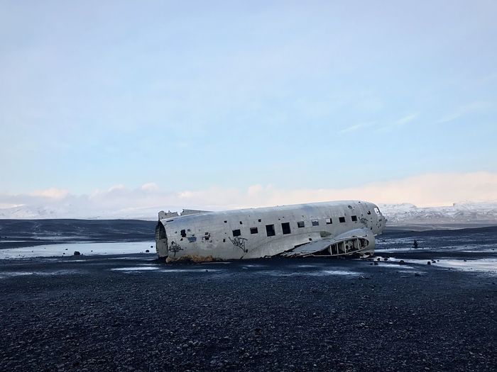 Dc-3 plane wreck on black sand beach in vik, iceland