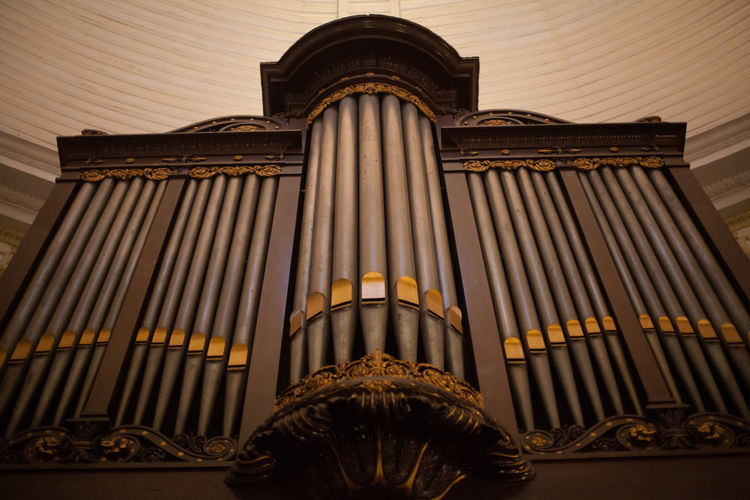Low angle view of pipe organ in church