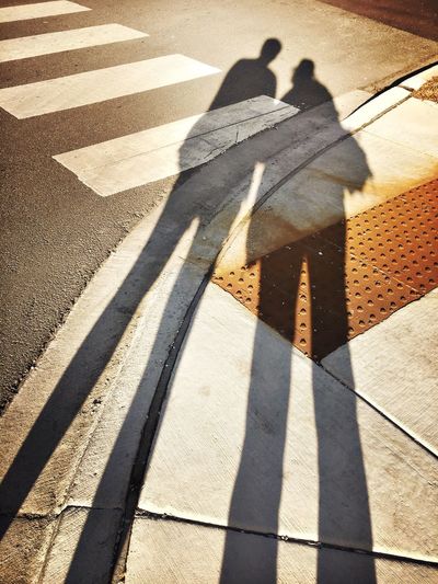 Shadow of people on road