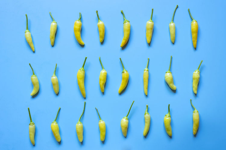 Directly above shot of fresh yellow pepper against white background