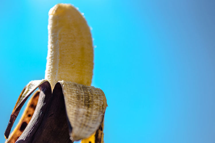 Close-up of banana against clear blue sky