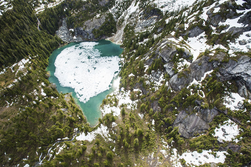 Aerial view of ice melting off alpine alpine lake, spring has arrived!