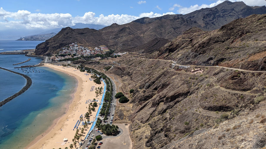 Scenic view of sea and mountains against sky