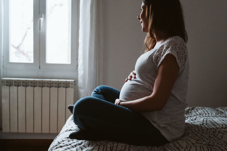 Pregnant woman spending leisure time at home