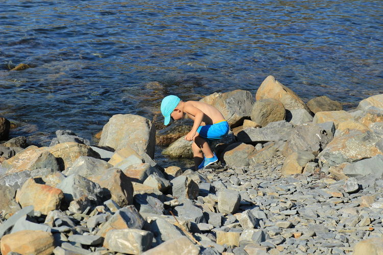 High angle view of man on rocks at shore