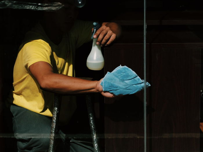 Man cleaning glass