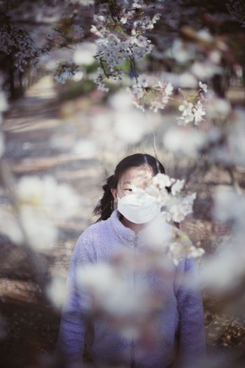 High angle view of girl wearing mask standing in park