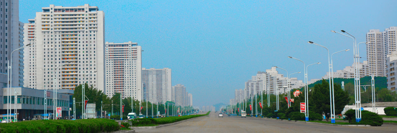 Street amidst buildings against clear sky
