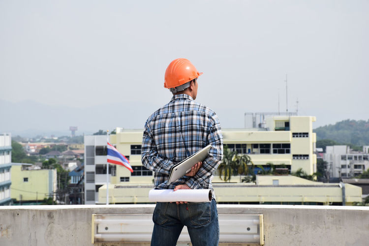 Rear view of man working at construction site