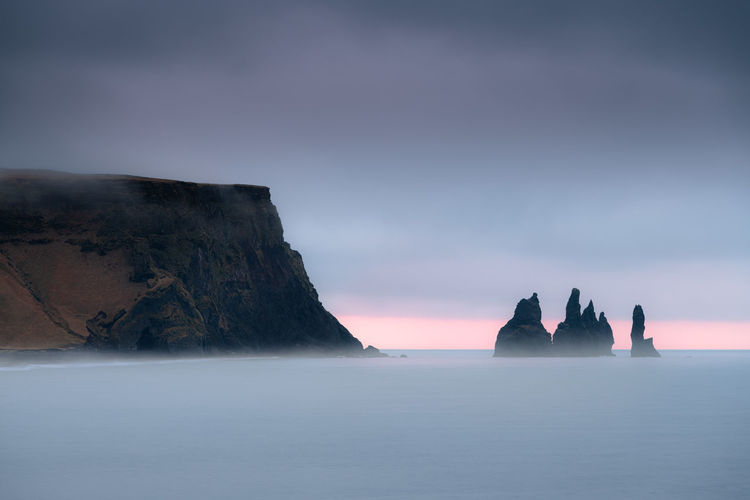 Scenic reynisdrangar cliff during sunrise on a stormy cloudy morning in iceland