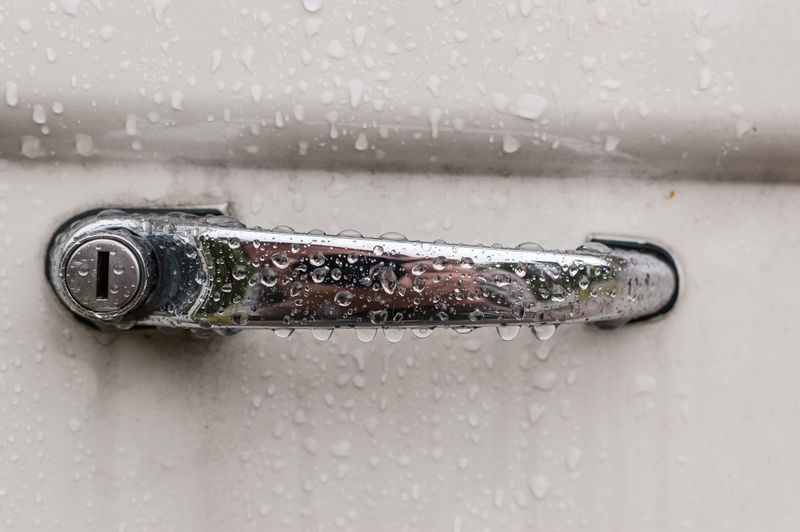 Close-up of wet car handle