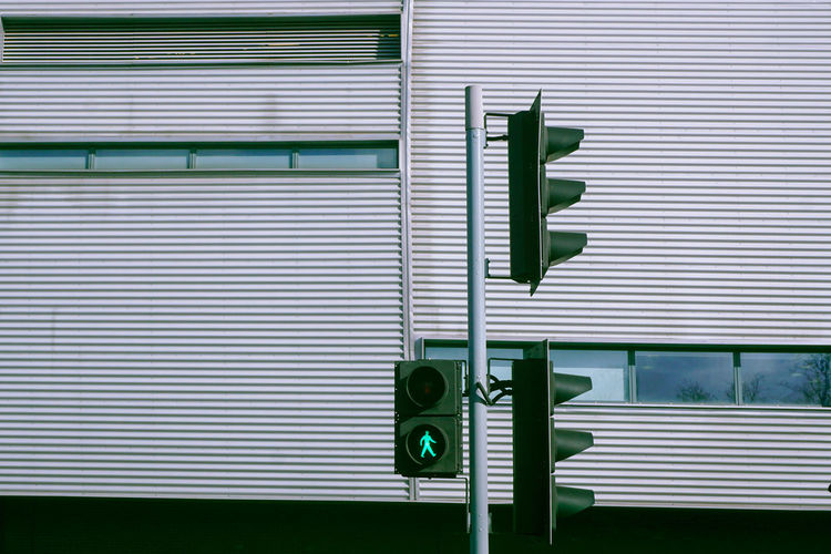 Low angle view of road signals against building in city