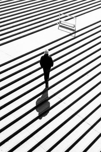 High angle view of man moving up steps