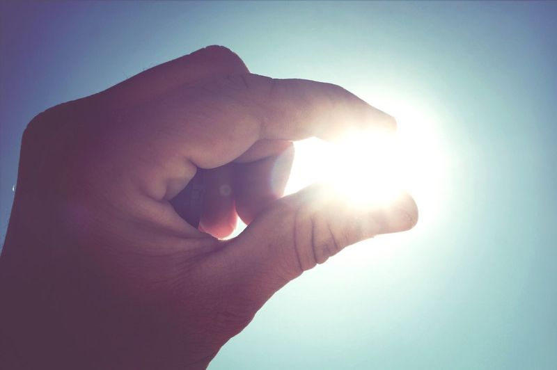 Close-up of hand holding sun
