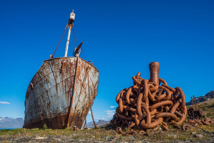 Old rusty ship against clear blue sky