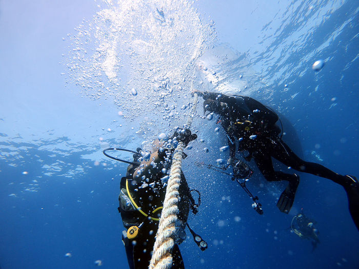 Divers hold onto the boat rope to wait for the surface. antalya turkey