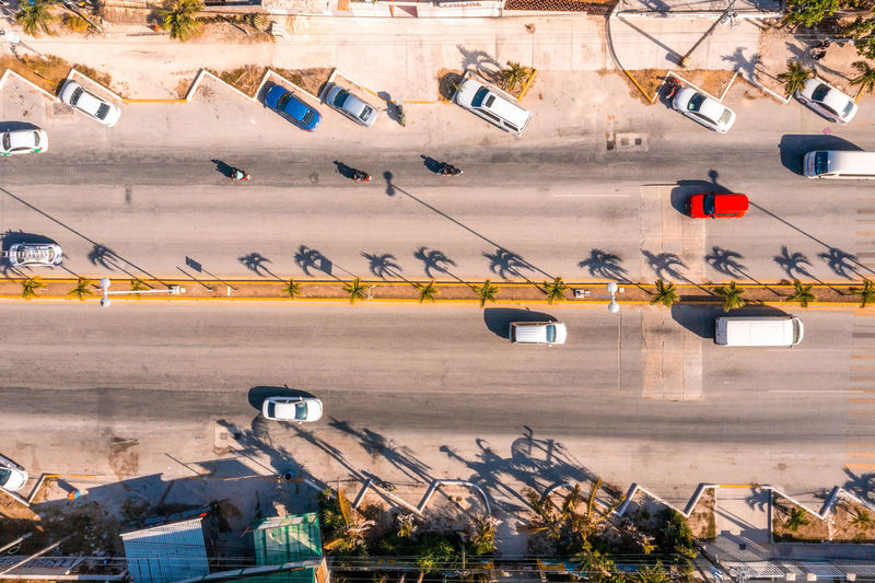 Aerial view of the street intersection with cars driving down the road.