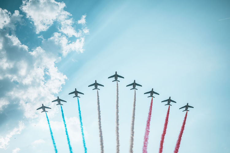 Low angle view of airplane flying against sky
