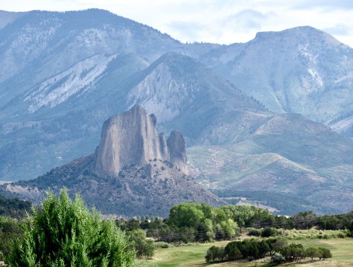Scenic view of mountains against cloudy sky