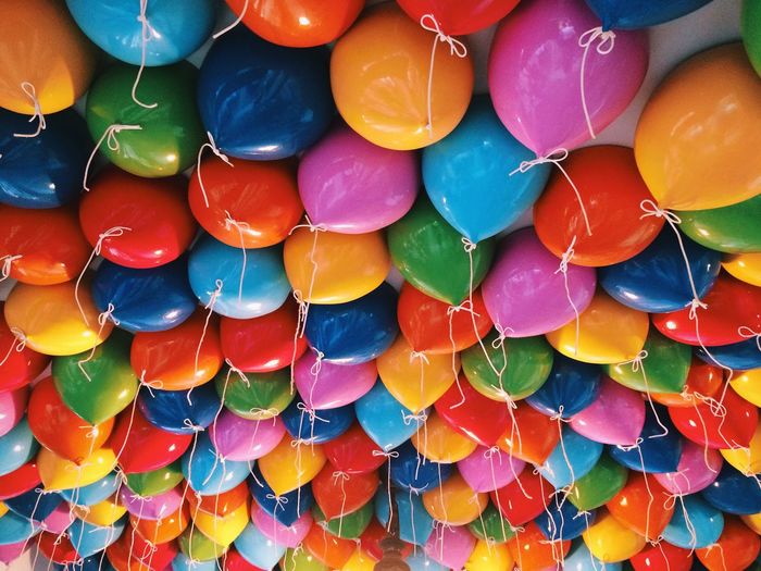 Full frame shot of colorful helium balloons against ceiling in portaventura