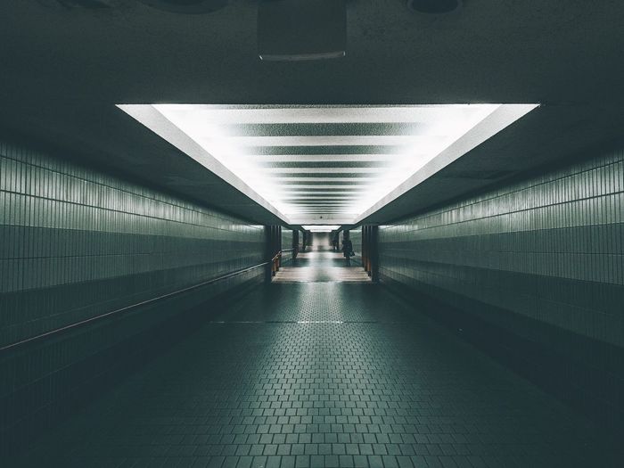 Empty underground walkway in tunnel