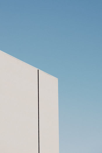 Low angle view of building against clear blue sky