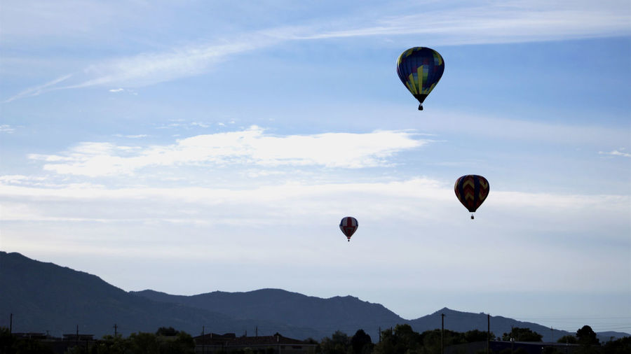 Hot air balloons in front of sandia mountains at dawn