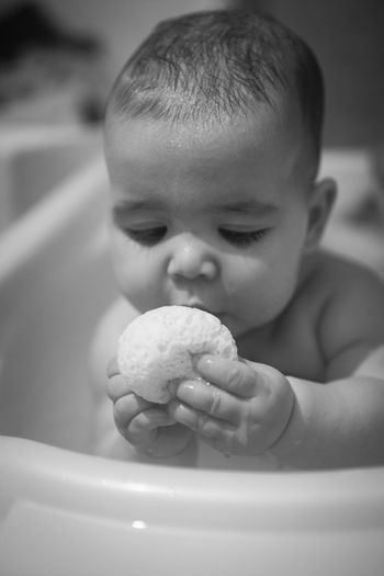 Close-up of cute baby girl in the bath