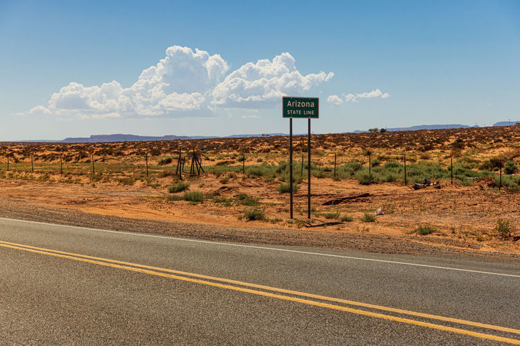 Arizona state line sign in the landscape near monument valley