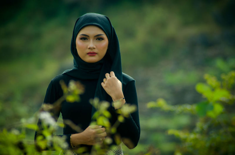 Portrait of young woman standing outdoors