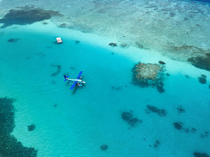 Aerial view of hydroplane floating in turquoise water of male atoll