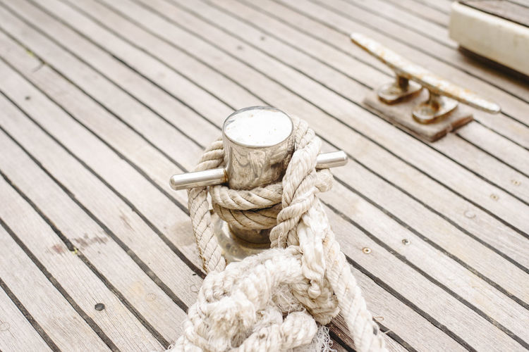 High angle view of rope tied on wooden post