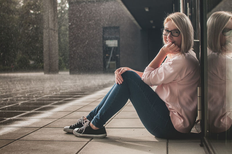 Cheerful woman sitting outdoors