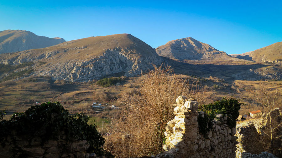 View of the abruzzo apennines from the medieval village of aielli, l'aquila italy. old stone walls.