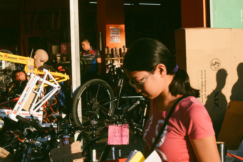 Young woman with bicycle standing in traditional clothing