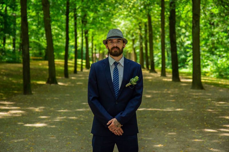 Portrait of groom standing in forest