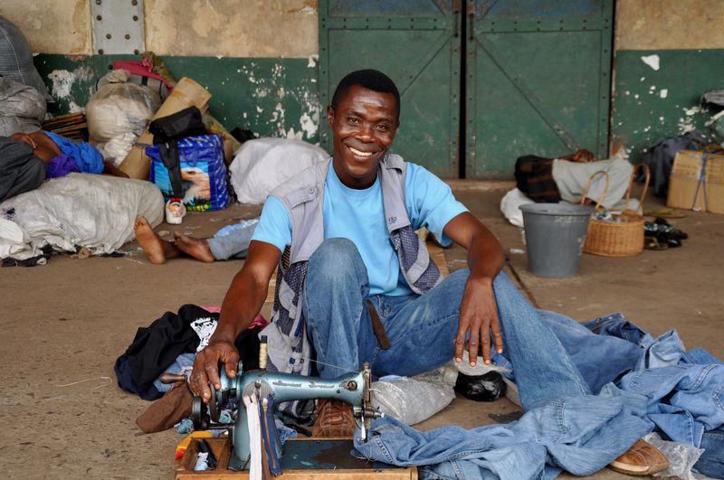 Portrait of man sewing jeans