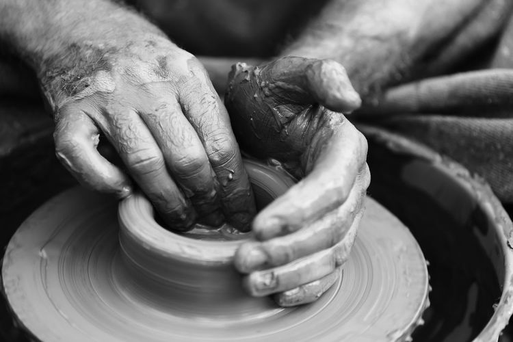 Cropped image of man working on pottery
