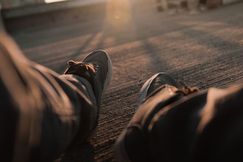 Low section of man wearing shoes
