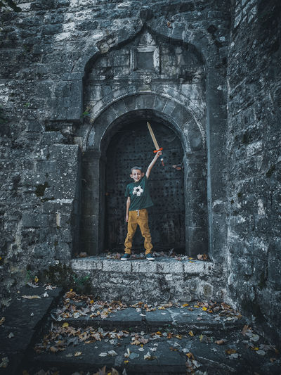 Man standing in front of old building
