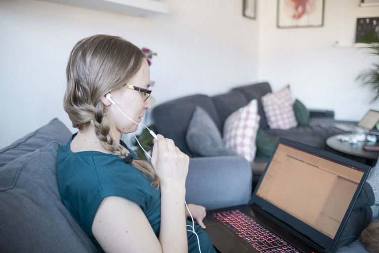 Woman in living room using laptop