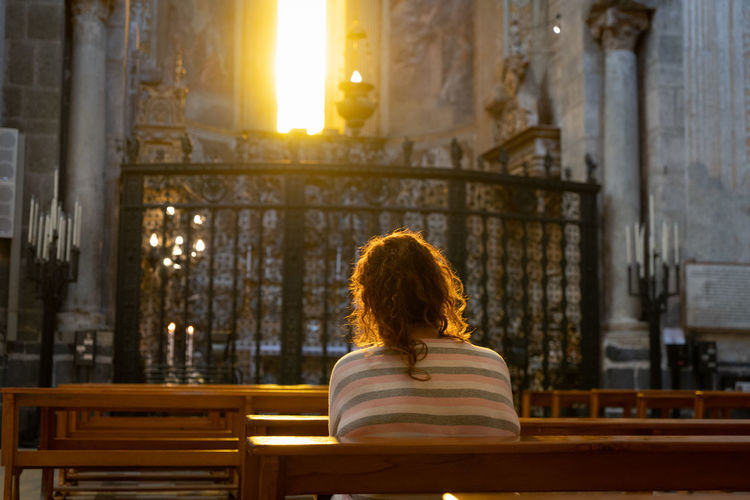 Rear view of woman sitting in church