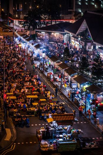 High angle view of people in street market at night