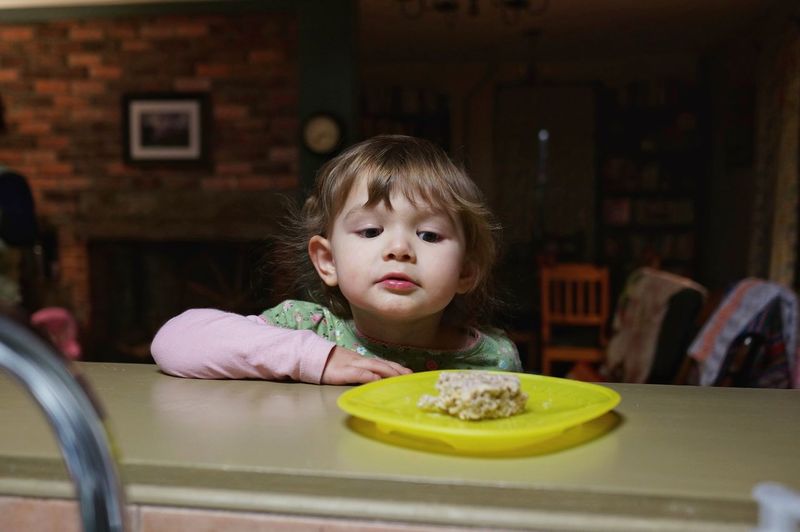 Portrait of child looking at food