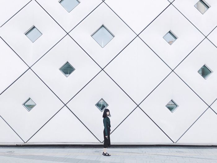 Woman walking by modern building