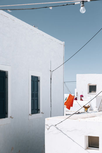 White buildings in milos, greece against blue sky