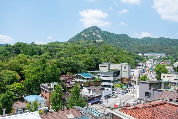 High angle view of townscape and mountains against sky