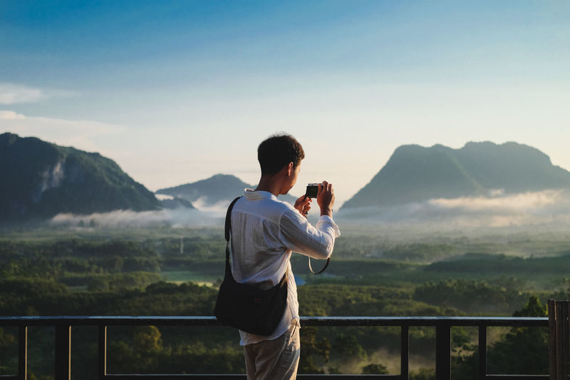 Full length of young man looking at mountains