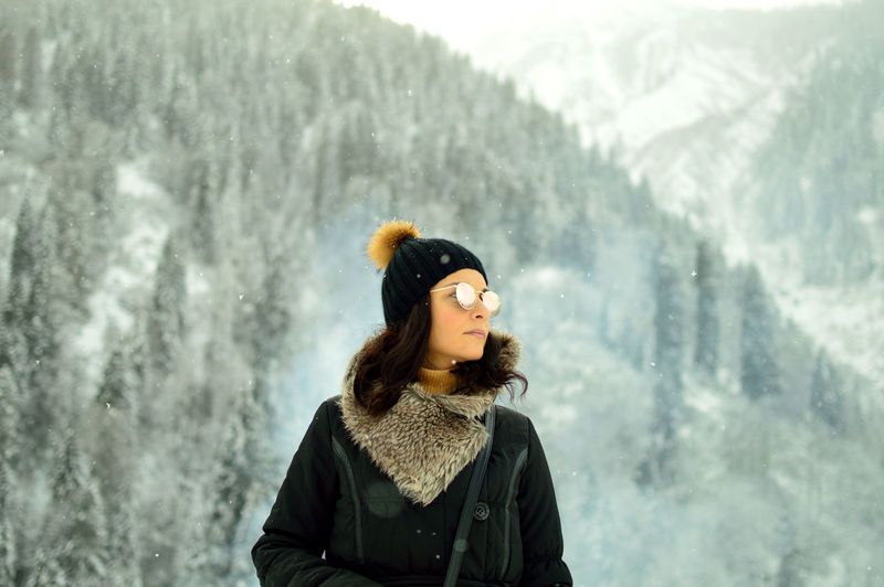 Portrait of a young woman in forest in snow